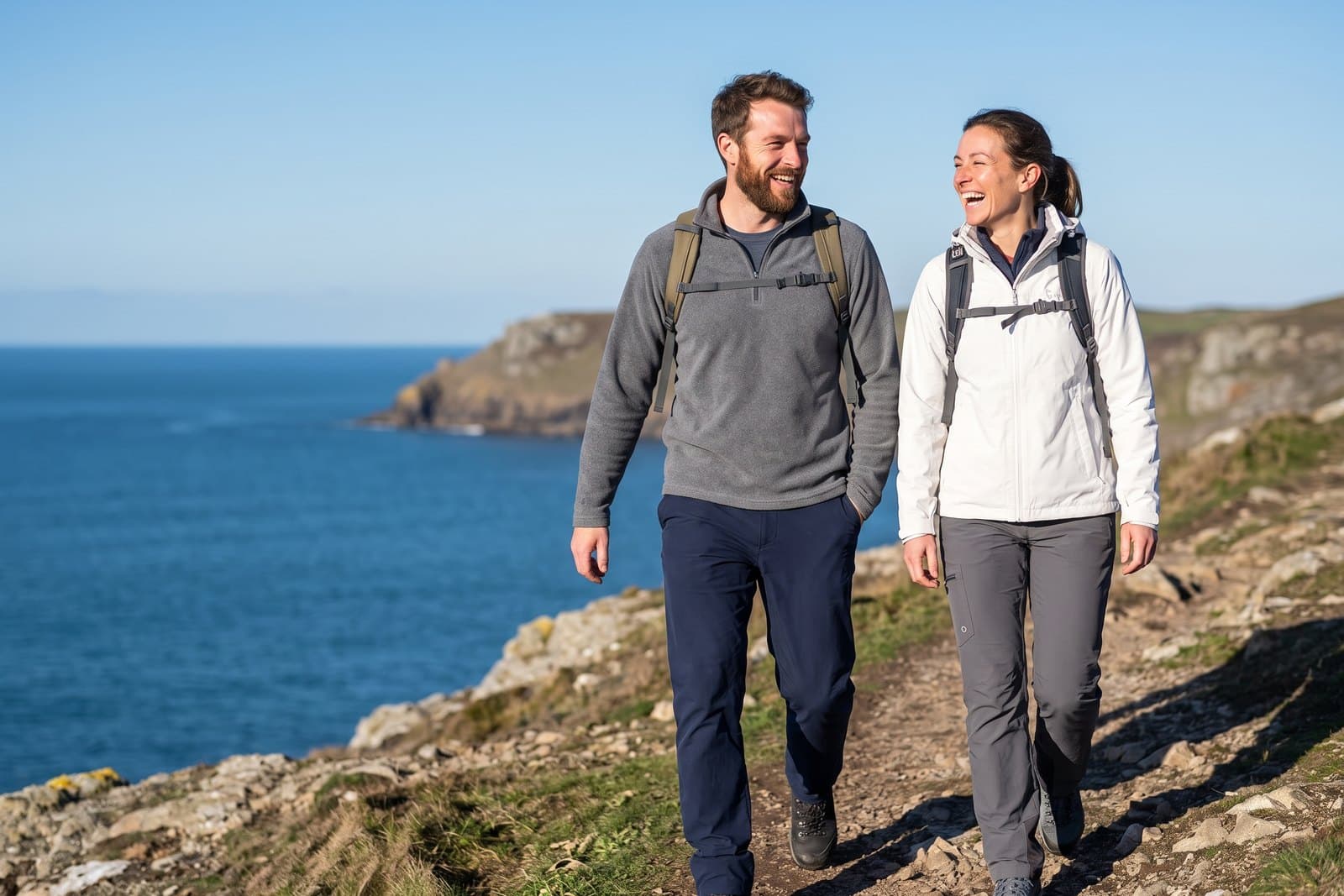 Two friends hiking along a coastal trail